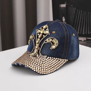 Detailed view of dark blue denim baseball cap featuring amber gems and sparkling rhinestones