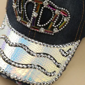Detailed macro view of the handmade rhinestones and crown pattern on the denim baseball cap