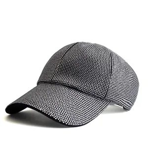 Close-up of black baseball cap with sparkling silver rhinestones and curved brim