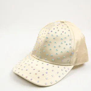 Close-up of sparkling colorful rhinestones on a premium champagne satin baseball cap