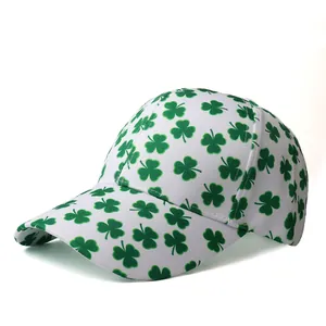 Detailed close-up of a white baseball cap with green clover pattern and curved brim