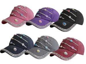 Close-up of floral rhinestones and silver bead accents on washed cotton baseball caps