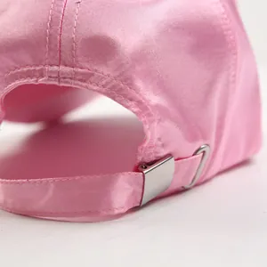 Pink satin baseball hat with crystal decor and adjustable metal buckle on back