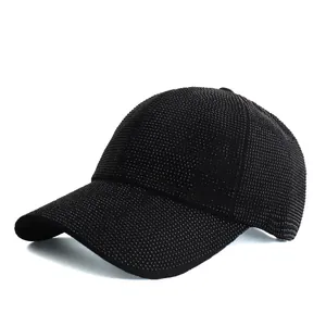 Detail of classic black baseball cap covered in dense rhinestones with curved brim