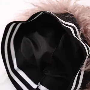 Knit beanie with brown faux fur trim and white stripes detail on a black base