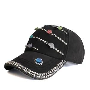 Detail of black baseball cap with colorful resin flowers and silver stud embellishments