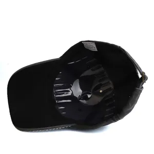 Detailed interior of a cotton baseball cap featuring metal rivets and an adjustable strap