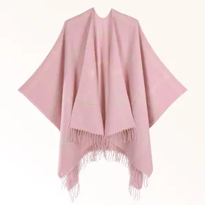 Detail of pink plaid cashmere-feel shawl with soft fringe trim and classic check pattern