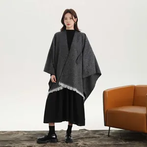 Close-up of vintage grey knit shawl detailing fringe trim and high-end twill texture