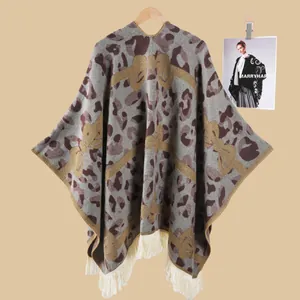 Detailansicht eines Ponchos mit Leopardenmuster, Schleife und weißen Fransen