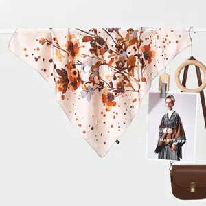 Elegant silk scarf with brown floral patterns draped over a rod for a vintage look