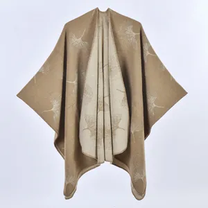 Brown knit poncho shawl featuring white ginkgo leaf jacquard patterns and soft fabric
