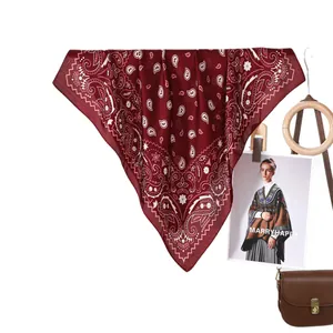 Classic burgundy paisley silk scarf styled with wooden ring and a leather crossbody bag
