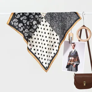 Classic silk scarf with paisley and polka dot patterns, paired with a leather saddle bag