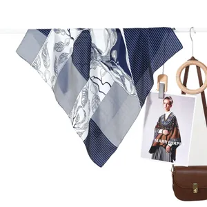 Classic blue and white striped silk scarf with plant patterns for women on a hanger