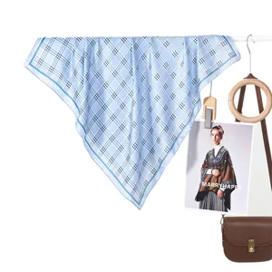 Classic blue checkered silk scarf elegantly draped with stylish fashion accessories