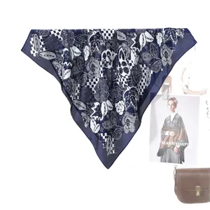 Navy blue checkered silk scarf with white floral patterns and matching leather handbag