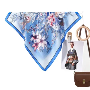 Classic floral print silk scarf for women in light blue with lily patterns and soft sheen