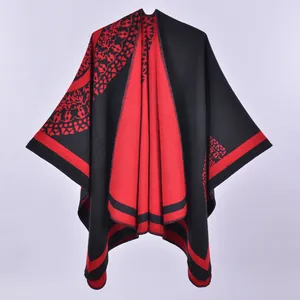 Thick warm double-sided poncho cape in red and black knit with geometric patterns