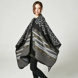 Women's knit poncho cape with grey diamond patterns and colorful striped hem details