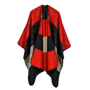 Close-up of thick knit color-block shawl with red, black, and beige stitching detail
