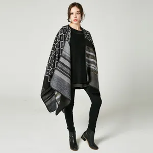 Detailed knit texture of a geometric diamond pattern oversized poncho cape with stripes