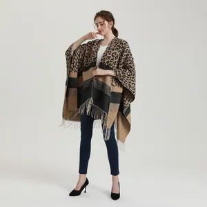 Detailed view of the knit poncho featuring leopard print patterns and stylish fringe hem