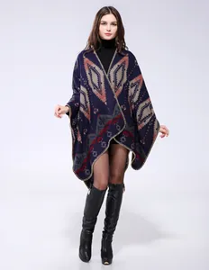 Close-up of geometric diamond knit shawl cape with ethnic pattern and thick fringe hem
