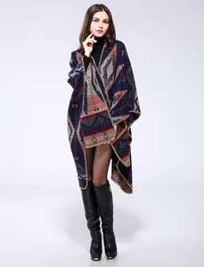 Close-up of bohemian knit poncho with geometric tribal patterns and stitched edges