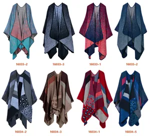 Macro detail of knitted Aztec poncho shawl featuring frayed fringe edges and vibrant patterns