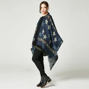 Close-up of navy knit poncho featuring star patterns and bohemian ethnic jacquard trim
