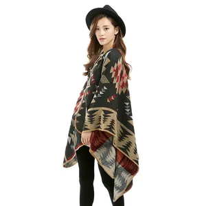 Detail of geometric knit pattern and fringed hem on warm cashmere-feel shawl cape