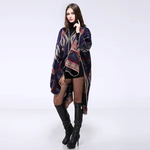 Detail of bohemian geometric knit poncho wrap with navy, red and grey tribal patterns