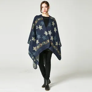 Detail of star pattern and geometric stripes on a navy blue cashmere-like poncho shawl