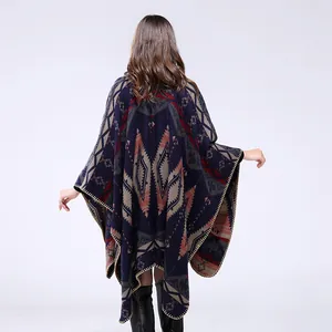 Detail of geometric pattern on navy knitted poncho shawl with ethnic tribal design