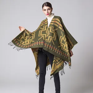 Close-up of olive green cashmere-like shawl with ethnic patterns and black fringe tassels