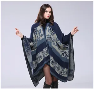 Detailed view of jacquard floral patterns and thick knitted texture on a navy blue shawl