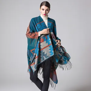Detail of bohemian knit shawl with geometric patterns and hanging black tassels