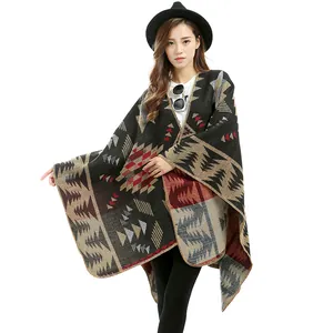 Detail of bohemian geometric pattern cashmere shawl with red and black knit edge