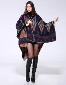 Detailed view of heavy knit poncho featuring geometric tribal patterns and blanket stitching