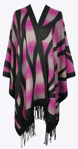 Close-up of pink and grey geometric knit shawl featuring long black fringe tassels