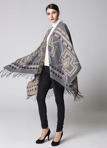 Close-up of geometric pattern and black tassel fringe on ethnic style shawl cape