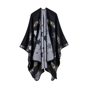 Detailed close-up of dark grey thick knit pashmina with star patterns and colorful trim