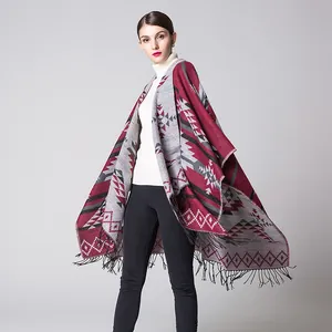 Macro detail of geometric ethnic pattern and fringe on burgundy cashmere-like shawl