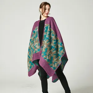 Detail of purple-edged camo knit poncho with thick texture and detailed stitching