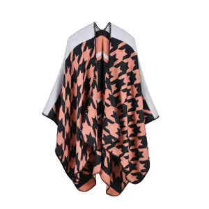Detailed view of women knit shawl with houndstooth pattern and black zigzag stitching