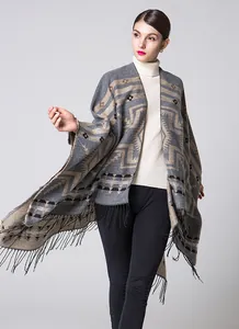 Close-up of thick ethnic shawl featuring geometric patterns and dense black fringe trim