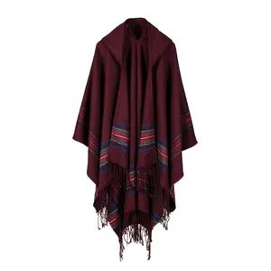 Close-up of wine red hooded shawl with colorful stripes and long fringe tassels