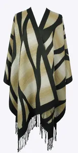 Detail of geometric knit pattern and fringe trim on a beige and black cashmere shawl
