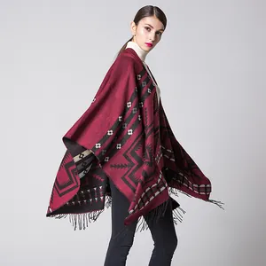 Close-up of ethnic style burgundy knit shawl featuring geometric patterns and black tassels